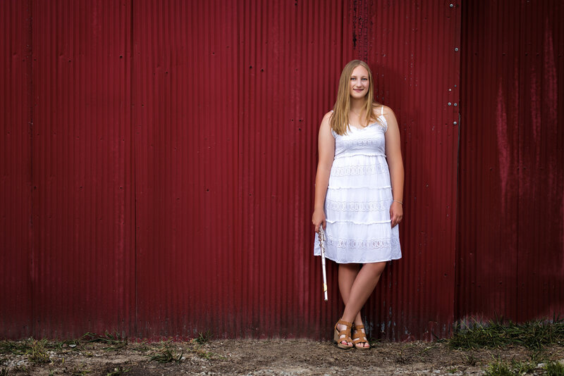 Senior portrait against red wall