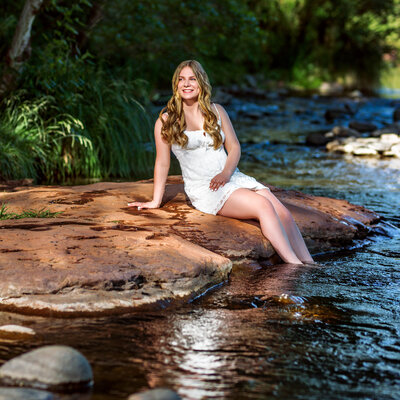 Woman on rock in creek